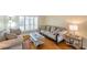Bright living room with a plush sofa, hardwood floors, and large windows that offer plenty of natural light at 815 Sandy Trail Pl, Brandon, FL 33511