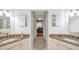 Dual sink primary bathroom featuring tiled floors and access to the en-suite main bedroom at 815 Sandy Trail Pl, Brandon, FL 33511