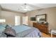 Primary bedroom with wood floors, ensuite bath, television, and comfortable appointments at 815 Sandy Trail Pl, Brandon, FL 33511