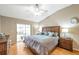Cozy primary bedroom featuring a ceiling fan, wood floors, and sliding door access to the outside at 815 Sandy Trail Pl, Brandon, FL 33511