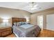 Comfortable primary bedroom featuring an en-suite bathroom, wood floors, and soft, natural lighting at 815 Sandy Trail Pl, Brandon, FL 33511