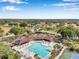 Community center and pool with lounge seating, palm trees and ample space to relax and play at 815 Sandy Trail Pl, Brandon, FL 33511