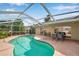 Inviting in-ground pool surrounded by a screened enclosure, perfect for relaxation at 815 Sandy Trail Pl, Brandon, FL 33511