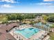 Aerial view of the community pool and amenities including lounge chairs, a playground, and tennis courts at 815 Sandy Trail Pl, Brandon, FL 33511