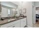 Bathroom featuring double sinks, granite countertops, and a large mirror at 8772 Flourish Dr, Land O Lakes, FL 34637