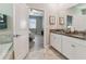 Bathroom featuring granite countertops, double sinks, and a large mirror at 8772 Flourish Dr, Land O Lakes, FL 34637