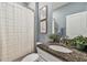 Stylish bathroom with granite countertop, patterned shower curtain, and neutral accents at 8772 Flourish Dr, Land O Lakes, FL 34637