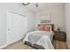 Comfortable bedroom featuring closet space, soft decor, and wood floors at 8772 Flourish Dr, Land O Lakes, FL 34637