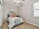 Cozy bedroom with natural light, wood floors, and serene decor at 8772 Flourish Dr, Land O Lakes, FL 34637