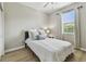 Bright bedroom with hardwood floors, a ceiling fan, a window, and neutral decor at 8772 Flourish Dr, Land O Lakes, FL 34637