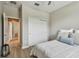 Well-lit bedroom featuring a closet and an open door leading to a glimpse of the hallway at 8772 Flourish Dr, Land O Lakes, FL 34637