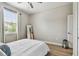 Bedroom with a large mirror, a ceiling fan, a window, and a wooden floor at 8772 Flourish Dr, Land O Lakes, FL 34637