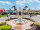 Community clubhouse featuring varied architecture, a central fountain and colorful building accents at 8772 Flourish Dr, Land O Lakes, FL 34637