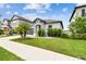 Charming single-story home with a well-manicured lawn and attached two-car garage at 8772 Flourish Dr, Land O Lakes, FL 34637