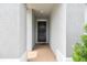 Welcoming front door with brick-style patio, offering a glimpse of the interior's neutral tones at 8772 Flourish Dr, Land O Lakes, FL 34637