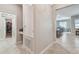 Hallway view with a laundry room, closet and open view of the kitchen and dining area at 8772 Flourish Dr, Land O Lakes, FL 34637