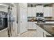 Bright kitchen features stainless steel appliances, white cabinets and granite countertops at 8772 Flourish Dr, Land O Lakes, FL 34637