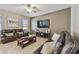 Spacious living room with tile floors, a ceiling fan, and comfortable leather seating at 8772 Flourish Dr, Land O Lakes, FL 34637