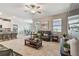 Open-concept living area with tile floors, modern furniture, and seamless flow to the kitchen at 8772 Flourish Dr, Land O Lakes, FL 34637