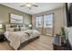 Spacious bedroom with lots of natural light, light-colored walls and wood flooring at 8772 Flourish Dr, Land O Lakes, FL 34637