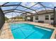 Large in-ground pool inside a screened enclosure and outdoor seating at 8772 Flourish Dr, Land O Lakes, FL 34637