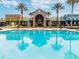 A pool with lounge seating surrounds the Splash Garden and other colorful community buildings at 8772 Flourish Dr, Land O Lakes, FL 34637