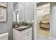 Charming powder room featuring granite countertop, vessel sink, and decorative accents at 8772 Flourish Dr, Land O Lakes, FL 34637