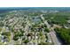 Neighborhood aerial view with nearby lake and highway; the home is highlighted with a red arrow at 8812 Beeler Dr, Tampa, FL 33626