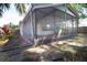 Screened-in patio in a backyard with stone pavers and foliage at 8812 Beeler Dr, Tampa, FL 33626
