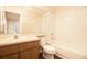 Clean bathroom with a tub and shower, updated vanity, and a large mirror for a bright and airy feel at 8812 Beeler Dr, Tampa, FL 33626