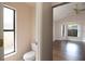 Bathroom featuring a commode, and view of the bedroom at 8812 Beeler Dr, Tampa, FL 33626