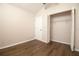 Bare bedroom with a closet, wood floors, neutral paint, and a door leading to additional rooms in the home at 8812 Beeler Dr, Tampa, FL 33626