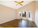 Bright bedroom featuring wood floors, a vaulted ceiling, a ceiling fan and a large bay window at 8812 Beeler Dr, Tampa, FL 33626