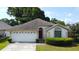 Charming single-story home with a well-manicured lawn and a two-car garage at 8812 Beeler Dr, Tampa, FL 33626