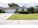 Charming single-story home with a manicured lawn and a two-car garage at 8812 Beeler Dr, Tampa, FL 33626