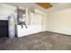 Utility closet area in a garage, featuring water heater and AC unit at 8812 Beeler Dr, Tampa, FL 33626