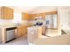 Well-lit kitchen featuring stainless steel appliances, light wood cabinetry, and a functional center island at 8812 Beeler Dr, Tampa, FL 33626