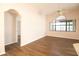 Bright living room featuring stylish wood floors, a ceiling fan, and large windows at 8812 Beeler Dr, Tampa, FL 33626