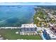 Aerial view of waterfront condos, a marina and expansive waterway surrounded by trees and houses at 920 N Osceola Ave # 301, Clearwater, FL 33755