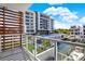 Stunning waterfront balcony view showcasing a modern building, pool, and dock at 920 N Osceola Ave # 301, Clearwater, FL 33755