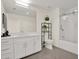 Bright bathroom features a modern vanity with white cabinets and a glass-enclosed shower at 920 N Osceola Ave # 301, Clearwater, FL 33755