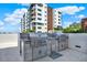 Outdoor kitchen setup featuring stainless steel grills and granite countertops, perfect for entertaining at 920 N Osceola Ave # 301, Clearwater, FL 33755