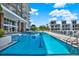 Long swimming pool surrounded by modern condo buildings and palm trees at 920 N Osceola Ave # 301, Clearwater, FL 33755