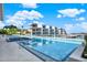 Large pool area with a hot tub surrounded by modern condo buildings and a view of the bay at 920 N Osceola Ave # 301, Clearwater, FL 33755