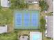 Aerial view showing the three well-maintained community tennis courts next to a swimming pool and some condos at 9209 Seminole Blvd # 12, Seminole, FL 33772