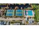Aerial view of the community including tennis courts, pool, pond, homes and mature trees at 10035 New Parke Rd, Tampa, FL 33626
