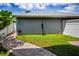 Lush backyard area featuring a well-maintained lawn, a charming pathway, and a privacy fence at 10035 New Parke Rd, Tampa, FL 33626