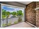 Brick balcony offering relaxing views of the neighborhood with lush trees under clear blue skies at 10035 New Parke Rd, Tampa, FL 33626