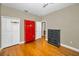 Bedroom featuring hardwood floors, lockers, a dresser, and ample space at 10035 New Parke Rd, Tampa, FL 33626
