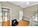 Bright bedroom with an adjacent hallway, featuring hardwood floors and neutral decor at 10035 New Parke Rd, Tampa, FL 33626